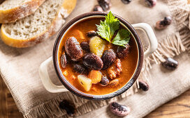Traditional bean soup with large beans, smoked meat, potatoes and carrots