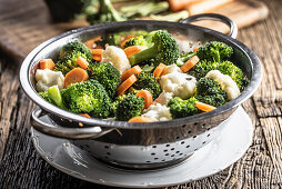 Broccoli, carrots and cauliflower in stainless steel steamer