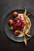 Black salsify and sesame cream with red cabbage and pomegranate salad and duck kofta