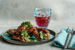 Fried chicken wings with coriander served with cherry cocktail
