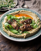 Chicken with hummus and cucumber and feta salad