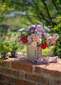 Bouquet of roses (Rosa), wild carrot, perennial vetch (Lathyrus latifolius), autumn anemone (Anemone Japonica), bearded flower (Caryopteris), oregano in a jug