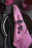 Sloe berries on cloth napkin dyed in sloe broth