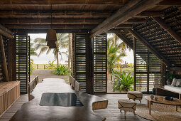 Living room of a sustainable house with bamboo construction and beach view