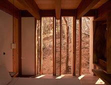 Bedroom with wood paneling and nature views, Casa Cometa, Mexico