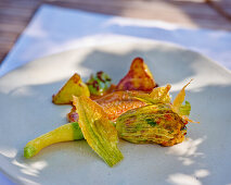 Fried red mullet fillet with stuffed courgette flowers and ratatouille jus