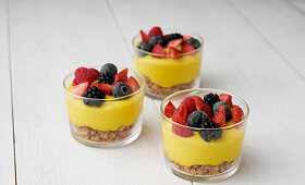 Mango cream with biscuit crumbs and fresh berries