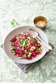 Beetroot spaghetti with peas, edamame, feta and mint