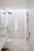 Modern bathroom with glass shower and white interior