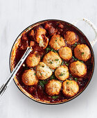 Italian beef ragout with garlic bread rolls