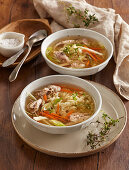 Chicken soup with vegetables, carrots, celery and fresh herbs