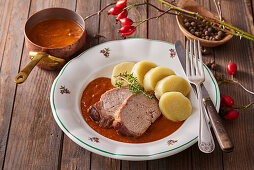 Roast wild boar with rosehip sauce and dumplings