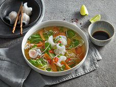 Asian soup with prawn dumplings and pak choi