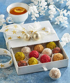 Colourful rum balls with nuts and coconut flakes