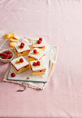 Sponge cake slices with raspberries and cream topping