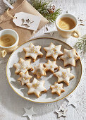 Star-shaped biscuits with plum jam filling and icing
