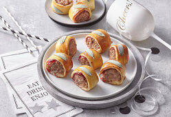 Minced meat rolls in puff pastry with cranberries and sage