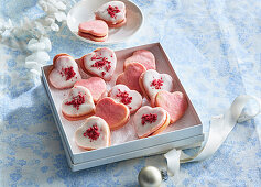 Heart-shaped biscuits with raspberry icing