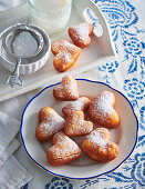 Heart-shaped doughnuts with icing sugar