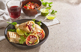 Burritos with pork, beans, avocado, tomatoes and coriander