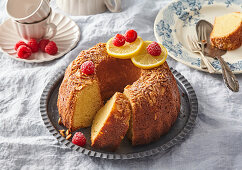 Lemon bundt cake with almond crust and fresh raspberries