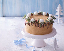 Winter festive cake with chocolate icing and rosemary