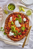 Pizza with minced meat base and avocado and pepper topping