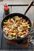 Salmon and pineapple pan with Chinese cabbage, courgette, ginger and coconut chips