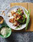 Wok-fried fish with peanuts and rice