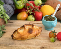 Empanada with chicken filling and chimichurri sauce