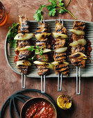 Grilled meat skewers with onions and coriander