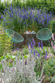 Seat between a bouquet of delphinium, dyer's chamomile (Anthemis tinctoria), candelabra speedwell and yarrow in a flower bed