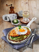 Crispy scrambled eggs on grey bread with gherkins and fried egg
