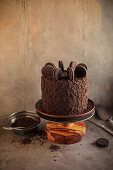 Chocolate cake with biscuit decoration on a cake plate