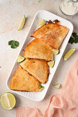 Lamb quesadillas with lime wedges and dip