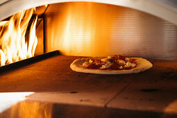 Pizza in a burning pizza oven