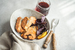 Red trout fish roasted in sauce served with dry red wine