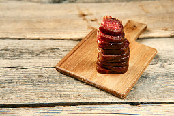 Stacked slices of smoked venison and beef salami