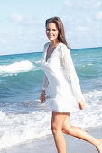 Young woman in white beach dress