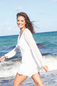 Young woman in white beach dress