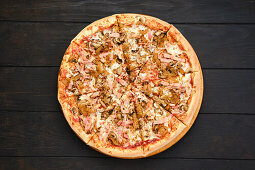 Pizza with ham, bacon, mushrooms and fried onions