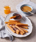 Churros mit Schokoladen-, Karamell- und Mangosauce