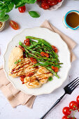 Grilled sea bass with green beans and tomatoes