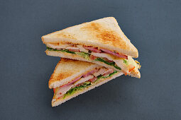 Club sandwich with cheese, bacon and ham