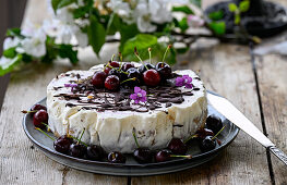 Orange ice cream tart with cherries and dark chocolate