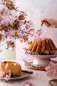 Cupcake with pink icing and cherry blossoms