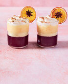 Mulled wine with whipped cream and orange slices