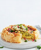 Vegetarian haloumi quiche with courgette and pomegranate seeds