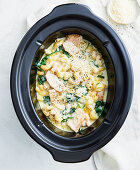 Creamy macaroni with chicken, cheese and spinach leaves