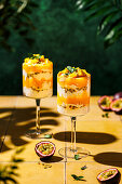 Mango and passion fruit layered dessert with mascarpone and quark cream